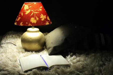 Reading on the carpet at night の写真素材