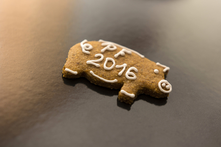 decorated gingerbread shaped piggy bank on a baking sheetの写真素材