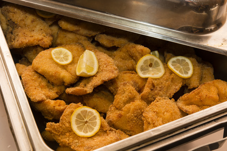 Stainless steel container with pulp and lemon slices.の写真素材