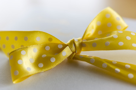 Yellow ribbons with white polka dots on a box in detailの写真素材