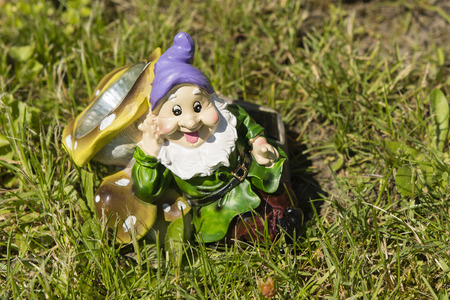 Dwarf as a bedside lamp lying in the grassの写真素材