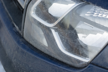 Dirty leading light in the car, the impact of road salt.の写真素材