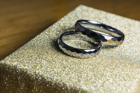 Two wedding rings made of tungsten on the box cover.の写真素材