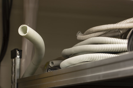 Plastic protective piping for cables in a shelf.の写真素材