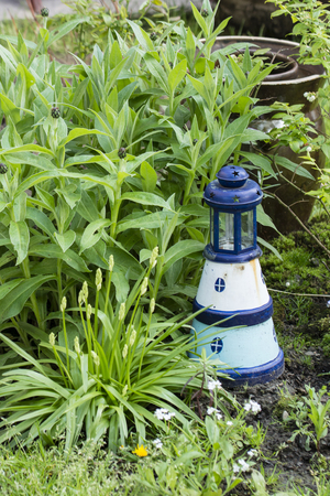 Decoration of the lighthouse next to the plant in the garden.の写真素材