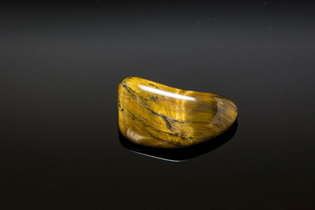 Cut ground glossy mineral stone tiger eye.の写真素材