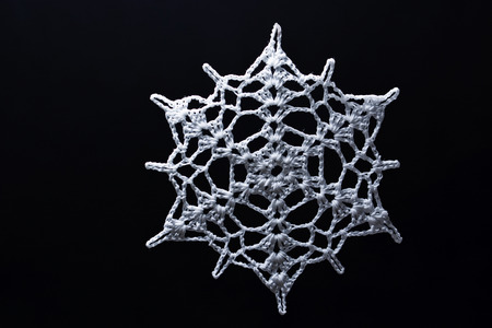 Snowflakes knitted white with black background.の写真素材