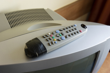 Old TV controller wrapped in tape.