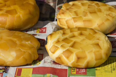 Loaves of smoked homemade cheese.の写真素材