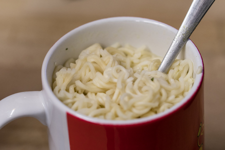 Chinese soup in a cup with a spoon.の写真素材