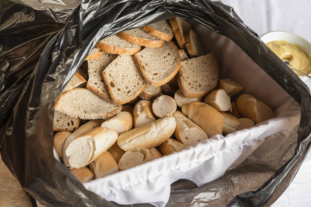 Crate with sliced ??bread and rolls in a sachet.の写真素材