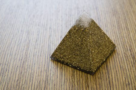 Orgonite - a pyramid with brass and crystal.