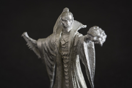 Tin figure of a magician with a crossbow.