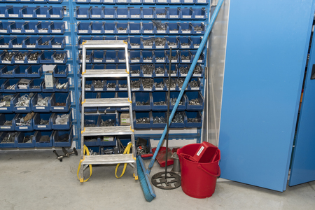 Plastic boxes with stainless steel and aluminum steps at the workshop near the cabinet.の写真素材