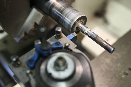Grinding of shaft on lathe.の写真素材