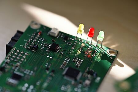 Three colored LEDs on a printed circuit board.の写真素材