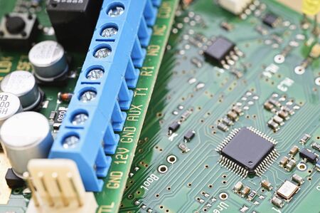 Blue terminal block on printed circuit board.