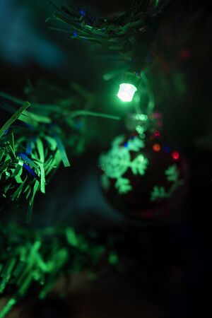 Green led light glowing on Christmas ball with snowflake.の写真素材