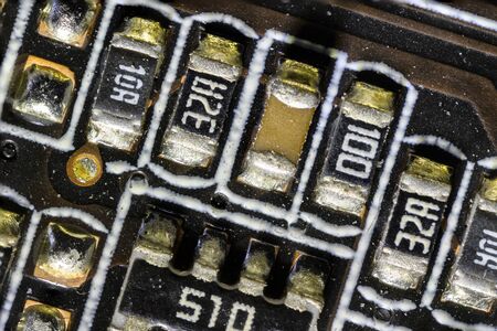 Resistors on computer motherboard in macro view.