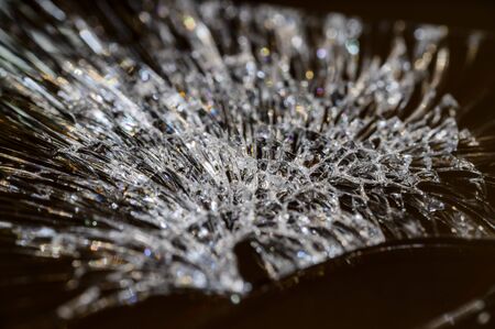 Cracks on the glass of a mobile phone in detail.の写真素材