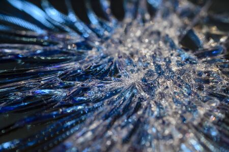 Cracks on the glass of a mobile phone in detail.の写真素材
