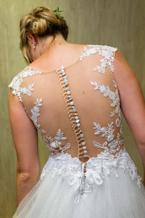 The back of the bride's wedding dress with buttons.の写真素材
