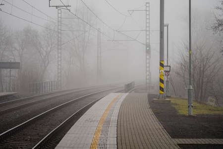 Tracks at the train station in foggy weather.
