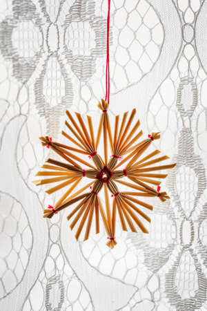 Hanging straw ornament on the curtain.
