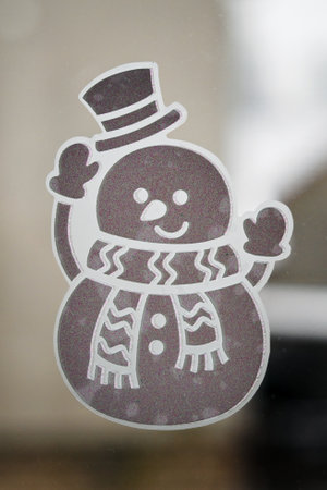 Sticky sticker snowman on the window.