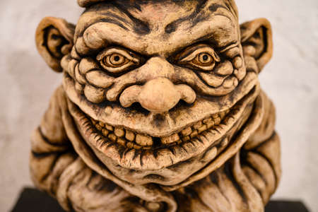 Ceramic figure of a leprechaun with a cap.の写真素材