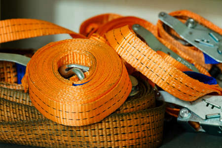 Curled orange cable ties lying on top of each other.の写真素材