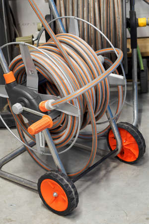 Two drums with wheels with a wound hose.