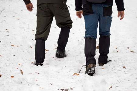 Two men walking through the snow.の写真素材