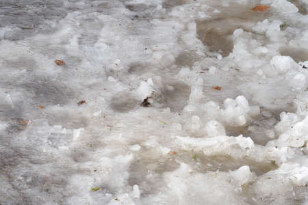 Slush and trampled snow with water.の写真素材