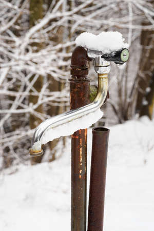 Water tap outdoors snowy simple.の写真素材