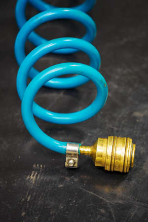 Brass air quick coupling and blue plastic hose.の写真素材