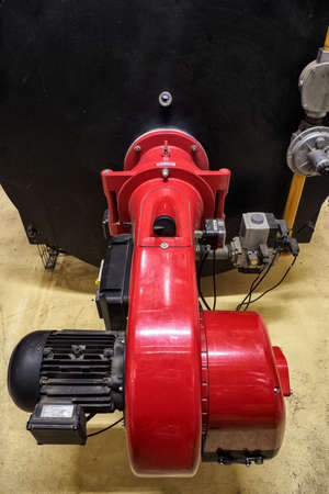 Burning flames in an industrial boiler for water heating.