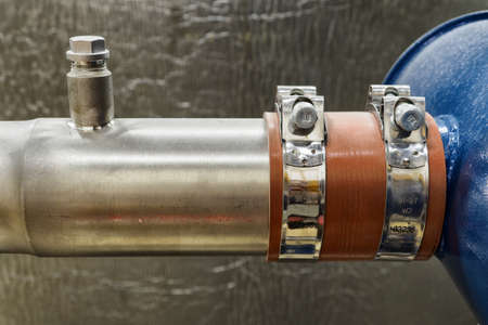 Metal clips on stainless steel pipes at the device.