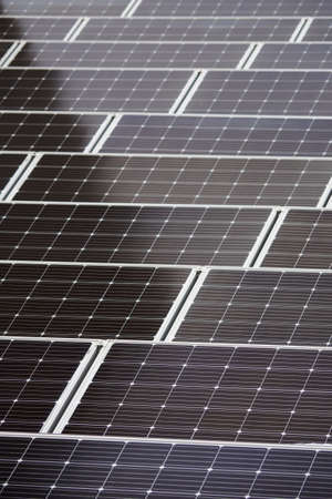 LED panel switched off between solar panels with snow.