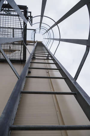 View of a metal ladder with a rest near the building.の写真素材