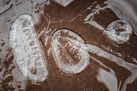Three large air bubbles under the frozen surface.