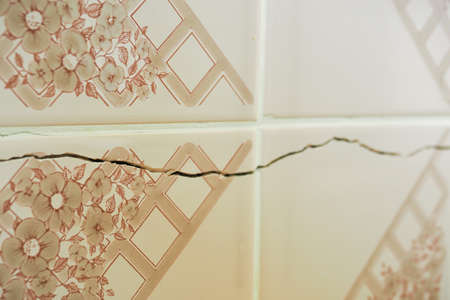 Cracked wall even through the tiles.の写真素材