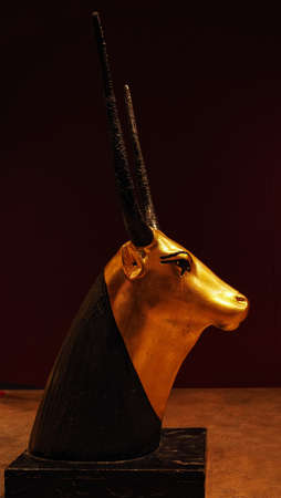 Gold figure of Egyptian divine cow in head detail.の写真素材