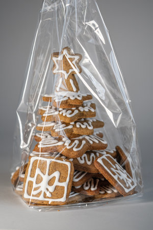 Gingerbread tree with gifts wrapped in cellophane.