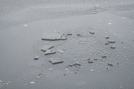 Broken ice on the pond frozen again.