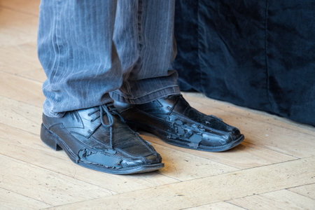Damaged social black men's shoes.の写真素材