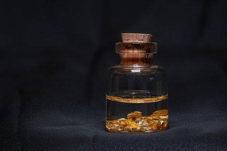 A small bottle of liquid and gold flakes.
