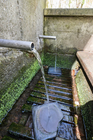 Stainless steel pipe with flowing healing water.