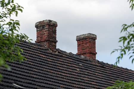 Two old red brick chimneys.の写真素材