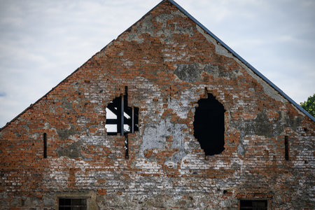 A wall in the gable of a house with a hole.